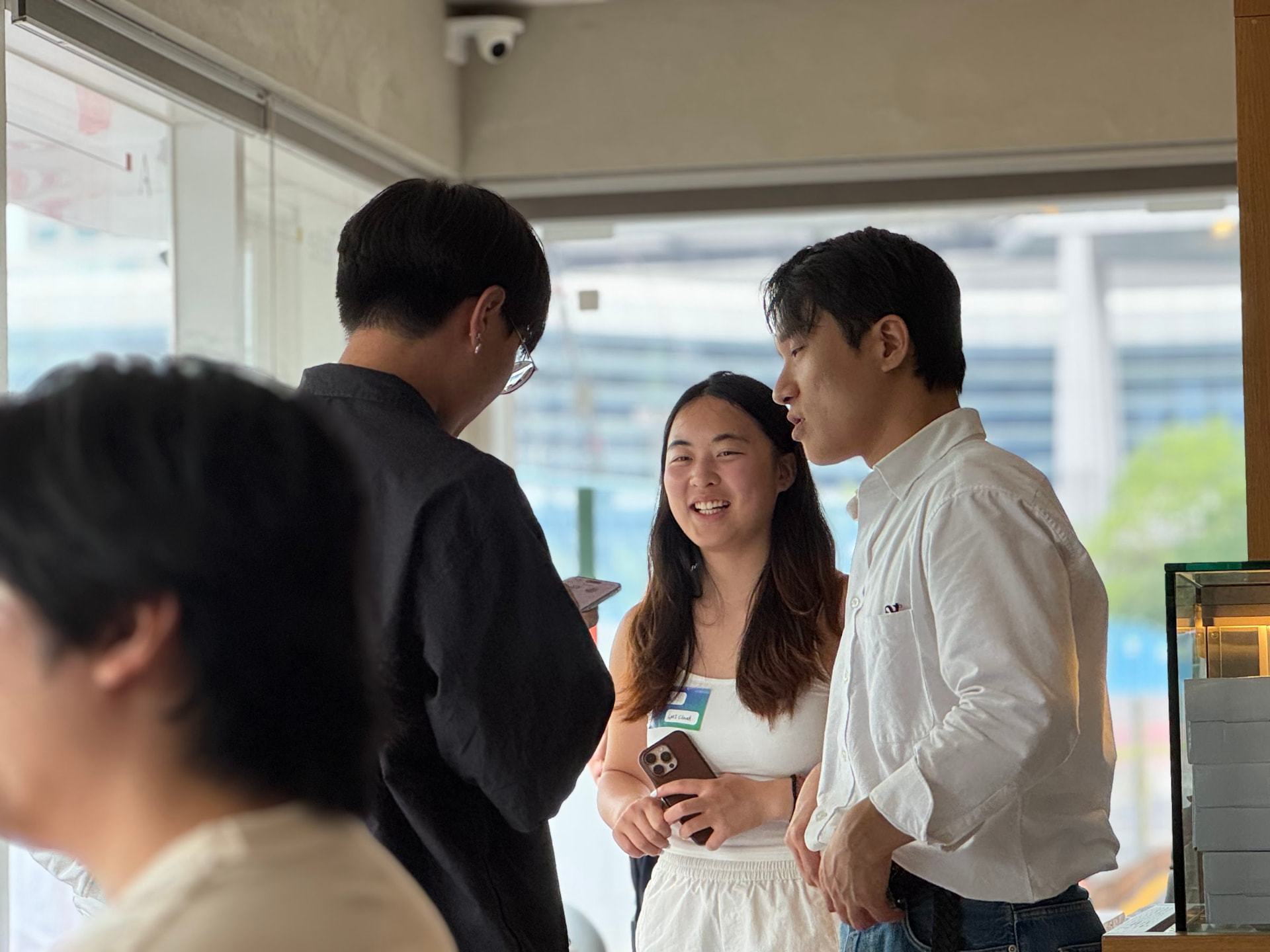 Guests laughing mid-conversation at Cafe GMI