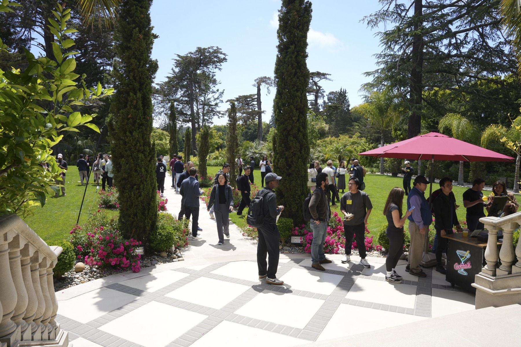 Demo Day guests talking in the AGI House garden